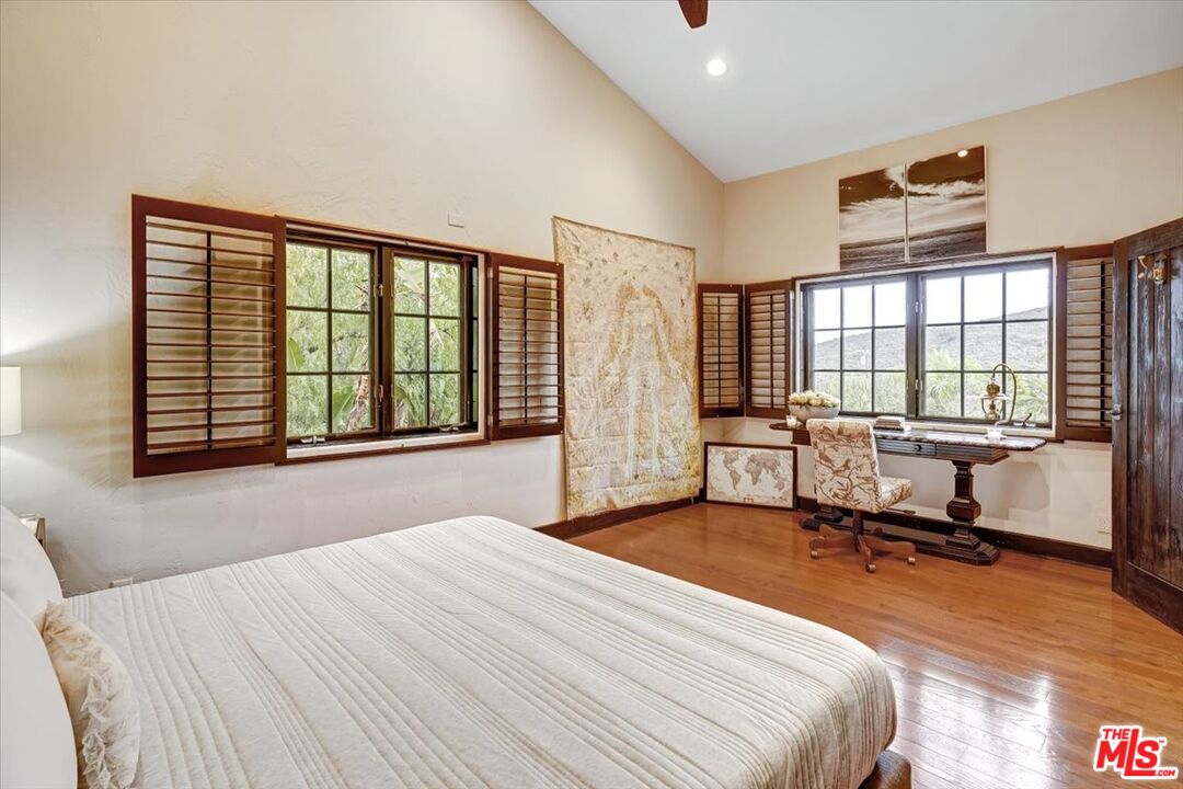 1351 Decker Road Malibu, CA 90265 - Photo 39 of 54 a bedroom with a bed large windows