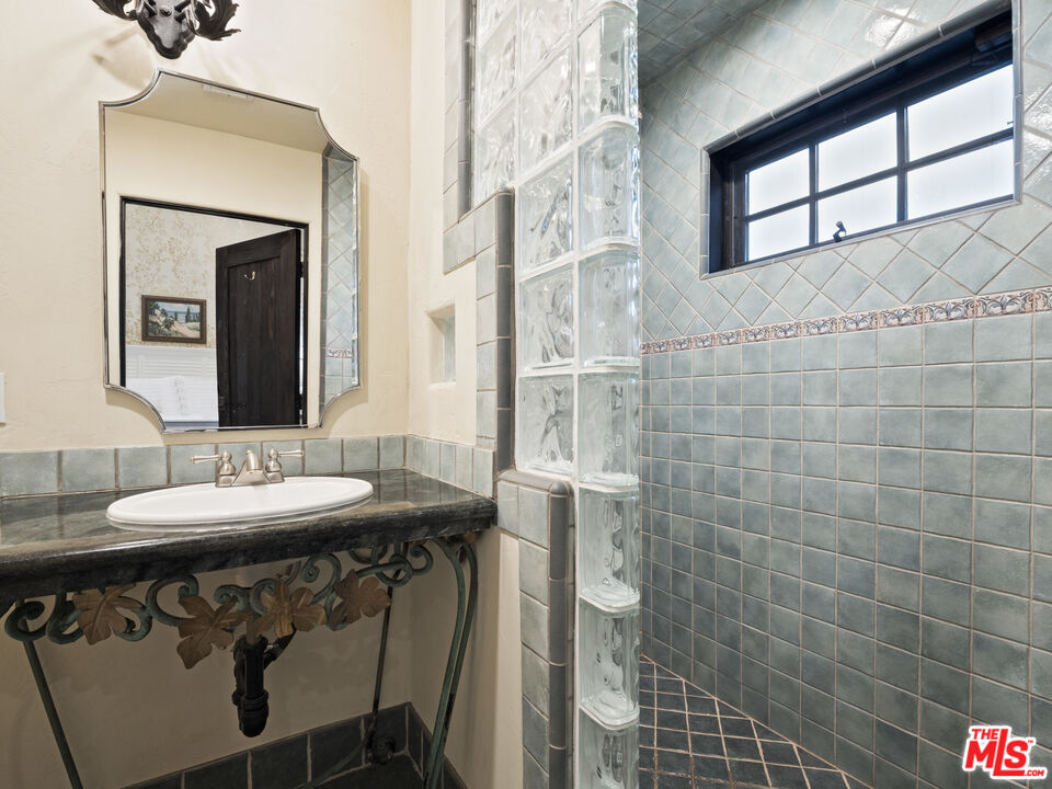 1351 Decker Road Malibu, CA 90265 - Photo 43 of 54 a bathroom with a sink and a mirror