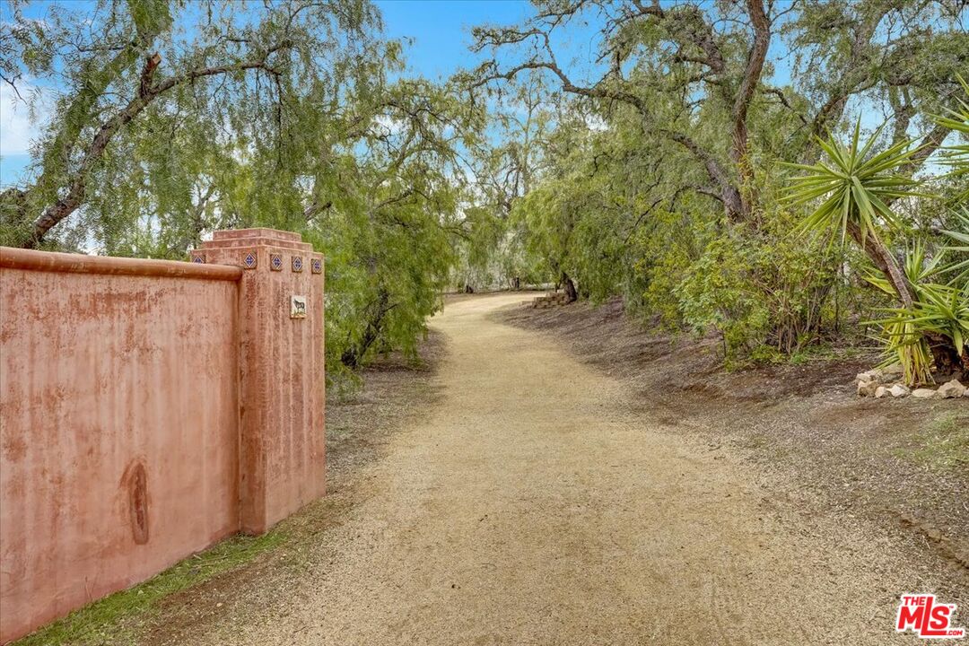 1351 Decker Road Malibu, CA 90265 - Photo 48 of 54 a view of a pathway of a yard with plants and trees