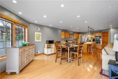 a large kitchen with lots of counter space dining table and chairs