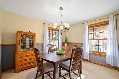 a dining room with furniture and window
