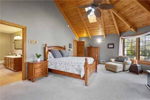 a bedroom with a bed and wooden cabinets