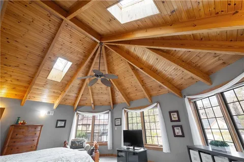a bedroom with furniture window and ceiling fan