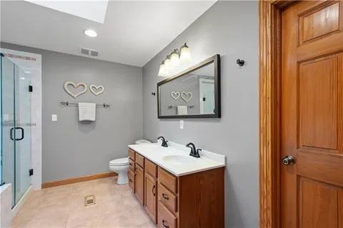 a bathroom with a sink mirror and vanity