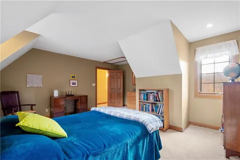 a bedroom with a large bed and a window