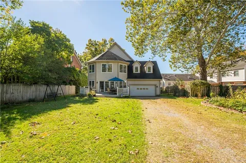 a view of a house with a yard patio and fire pit