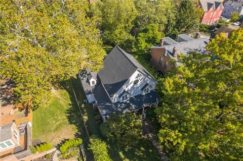 an aerial view of residential house with green space