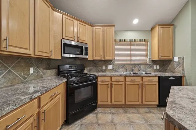 a view of empty room with wooden floor and window