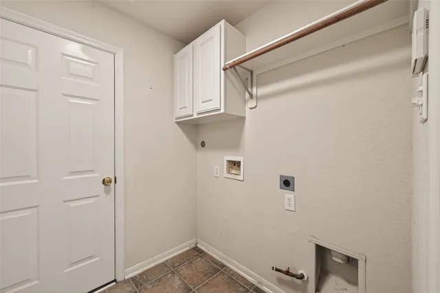 a view of a room with wooden floor and chandelier