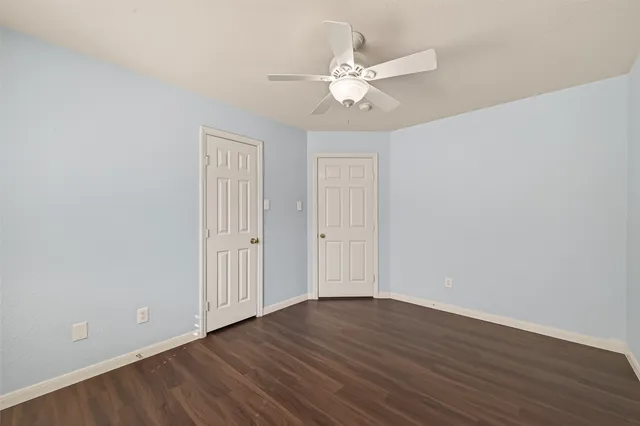 a kitchen with granite countertop white cabinets and stainless steel appliances