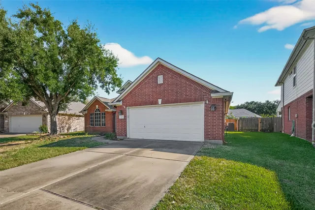 a kitchen with granite countertop a sink a stove and cabinets