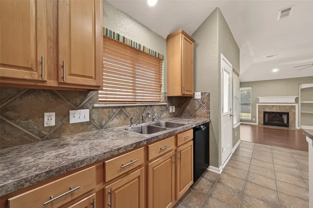an empty room with wooden floor and chandelier fan