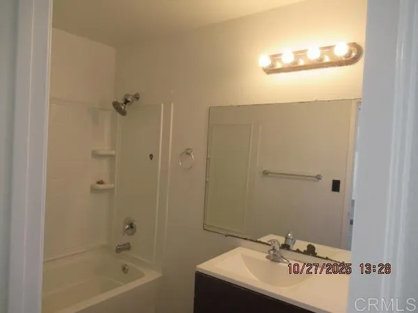 a bathroom with a sink a mirror and a bathtub