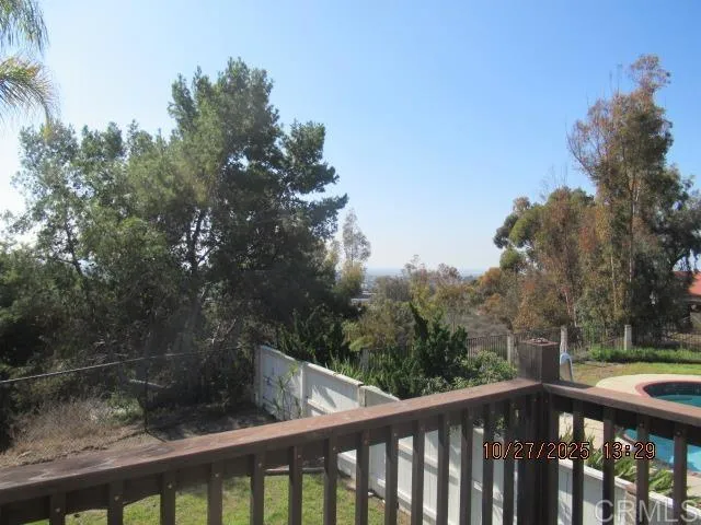 a view of a balcony with wooden fence and floor