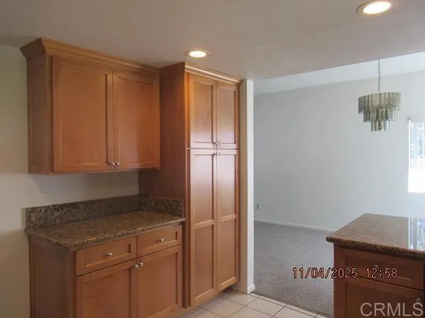 a kitchen with a refrigerator and cabinets