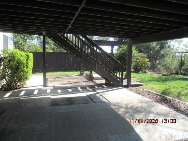 a view of a patio with a table and chairs next to a yard