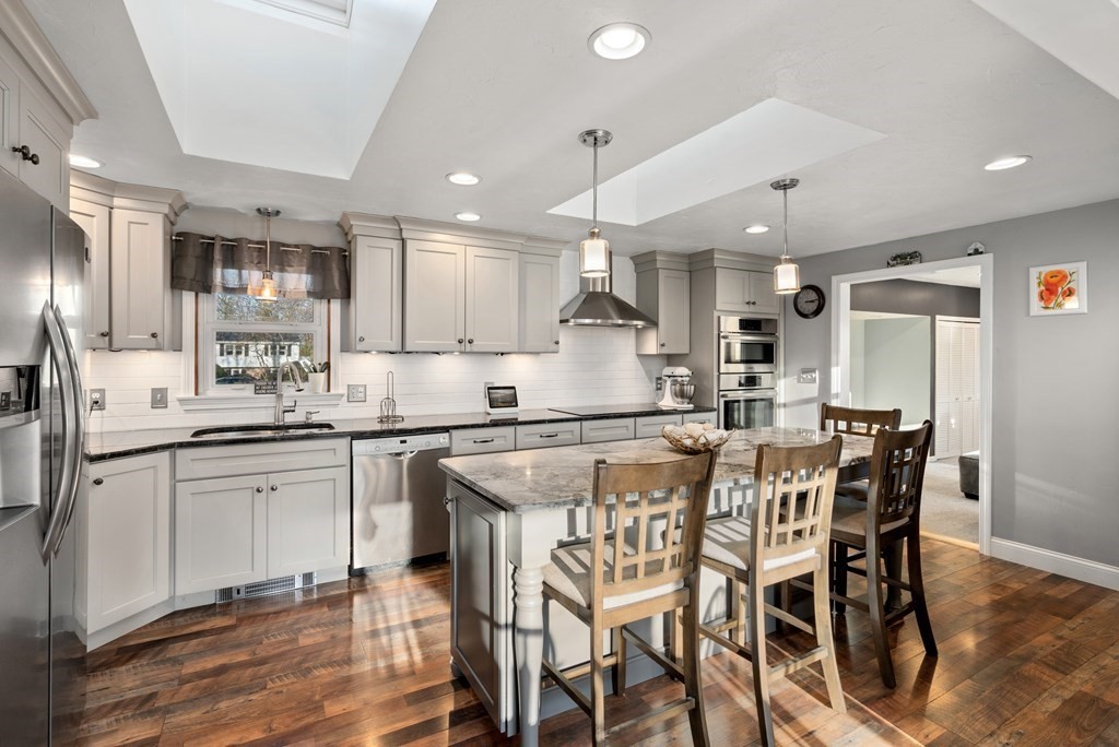5 Myrtle Street Mendon, MA 01756 - Photo 3 of 22 a kitchen with stainless steel appliances kitchen island granite countertop a table chairs sink and cabinets