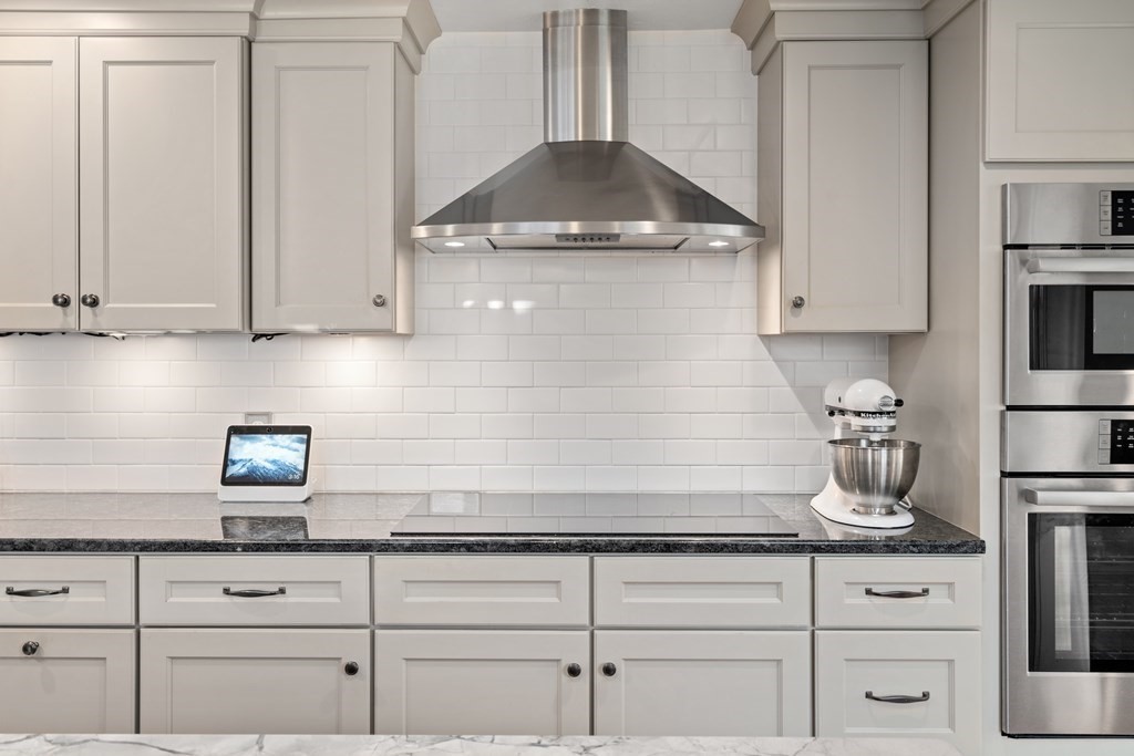 5 Myrtle Street Mendon, MA 01756 - Photo 5 of 22 a kitchen with white cabinets and a stove