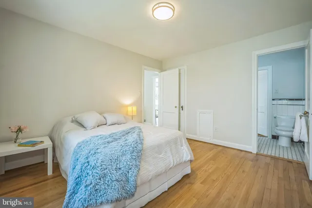 a spacious bedroom with a bed and a table