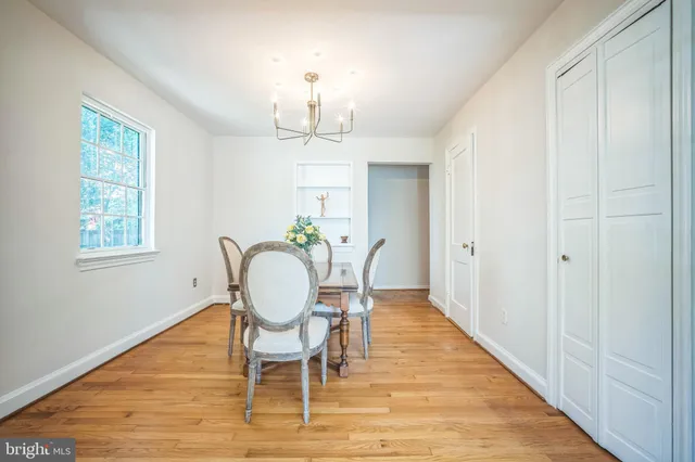 a view of a dining room with furniture a chandelier and wooden floor