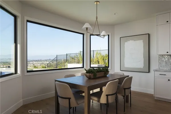 a view of a living room with furniture and a floor to ceiling window