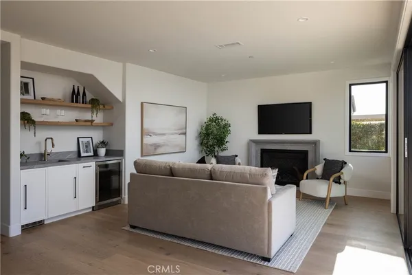 a living room with fireplace furniture and a large window