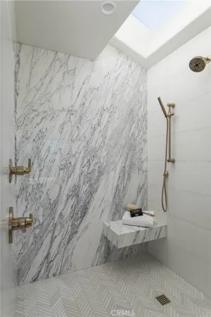 a spacious bathroom with a double vanity sink a large mirror and a bathtub
