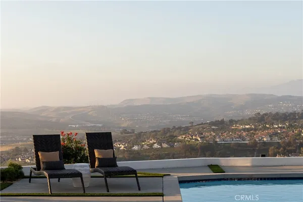 a swimming pool view with a seating space