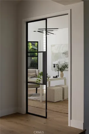 a living room with furniture a window and wooden floor