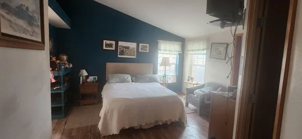 a bedroom with a bed and a mirror