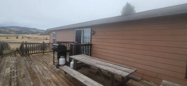 a view of a roof deck with wooden floor