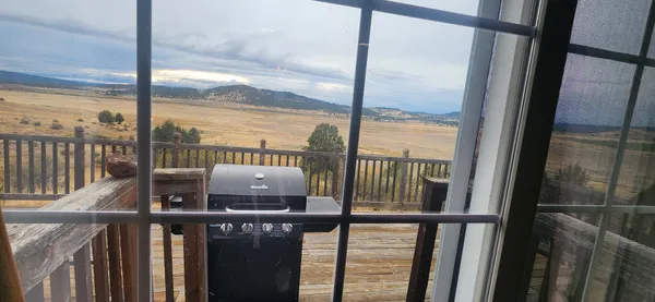 a view of a balcony with floor to ceiling window with wooden floor