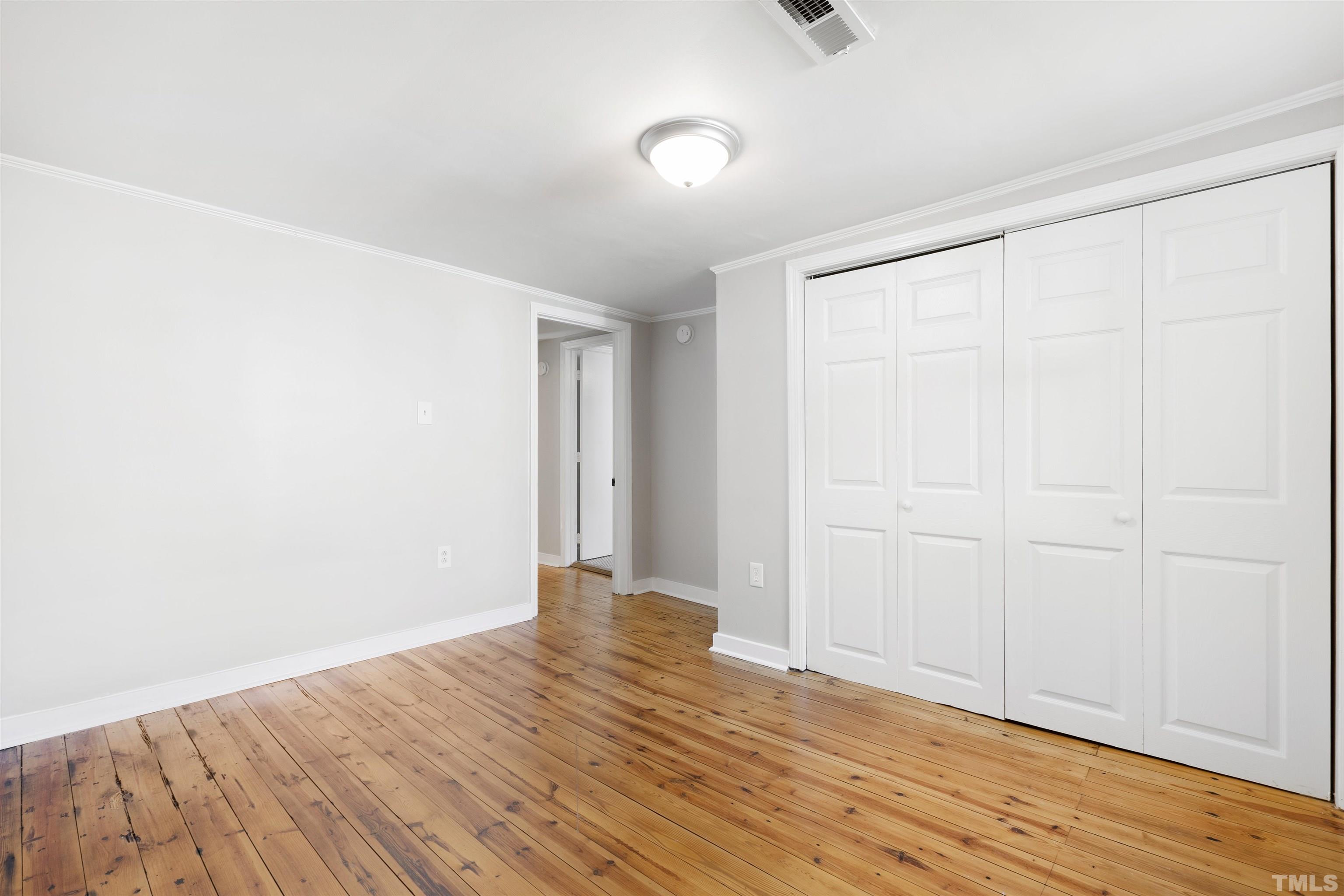5524 Bobbitt Road Apex, NC 27539 - Photo 12 of 24 a view of an empty room with wooden floor