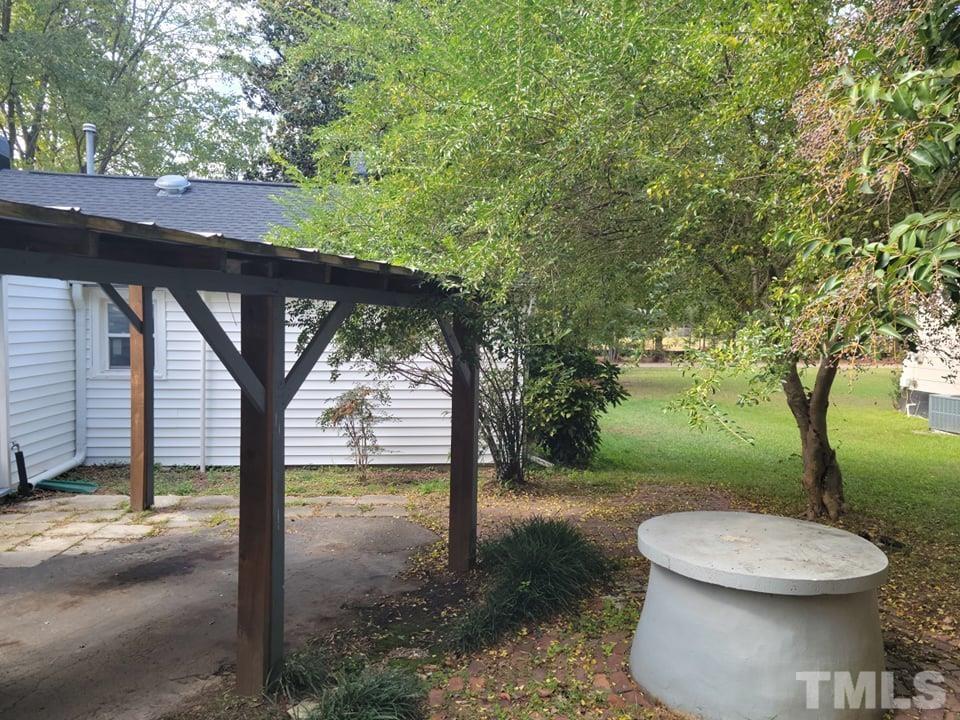 5524 Bobbitt Road Apex, NC 27539 - Photo 4 of 24 a view of a backyard with a fountain