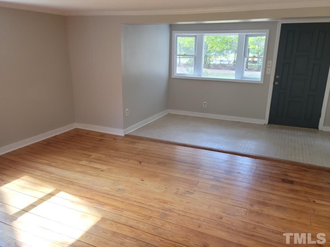 5524 Bobbitt Road Apex, NC 27539 - Photo 5 of 24 an empty room with wooden floor and windows