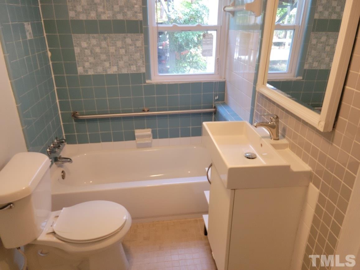5524 Bobbitt Road Apex, NC 27539 - Photo 6 of 24 a bathroom with a sink a toilet and bathtub