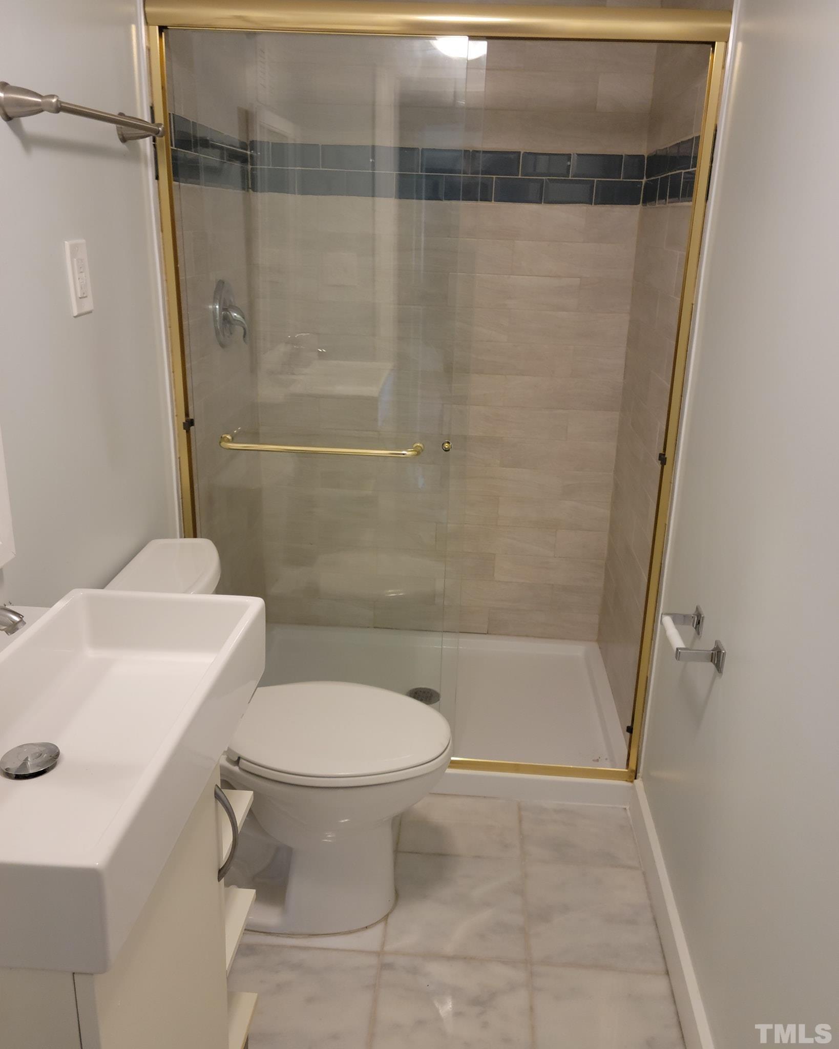 5524 Bobbitt Road Apex, NC 27539 - Photo 8 of 24 a bathroom with a toilet and a shower