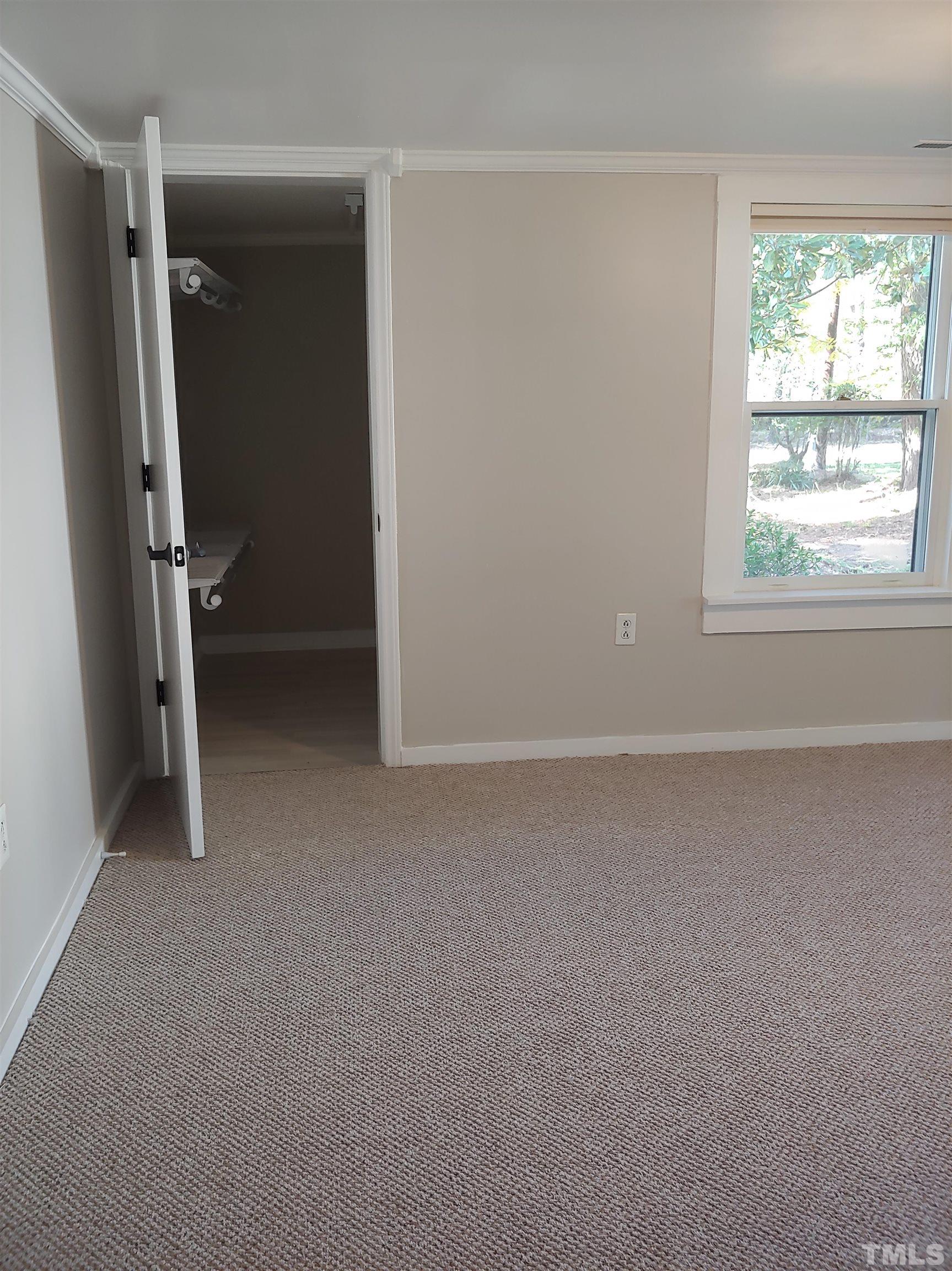 5524 Bobbitt Road Apex, NC 27539 - Photo 10 of 24 an empty room with windows and closet