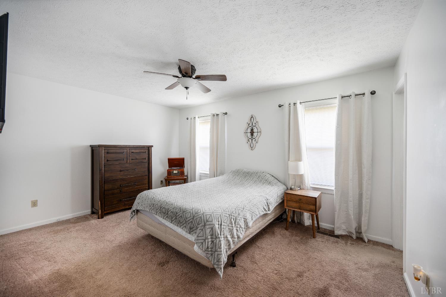 2050 Hawkins Mill Road Lynchburg, VA 24503 - Photo 13 of 32 a bedroom with a bed and a chandelier
