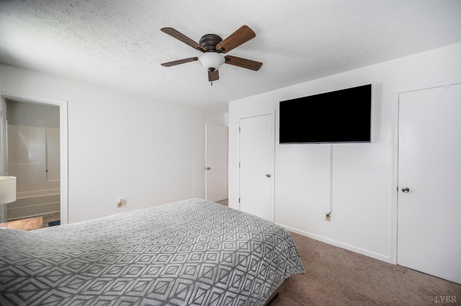 2050 Hawkins Mill Road Lynchburg, VA 24503 - Photo 14 of 32 a bedroom with a large bed and a flat screen tv