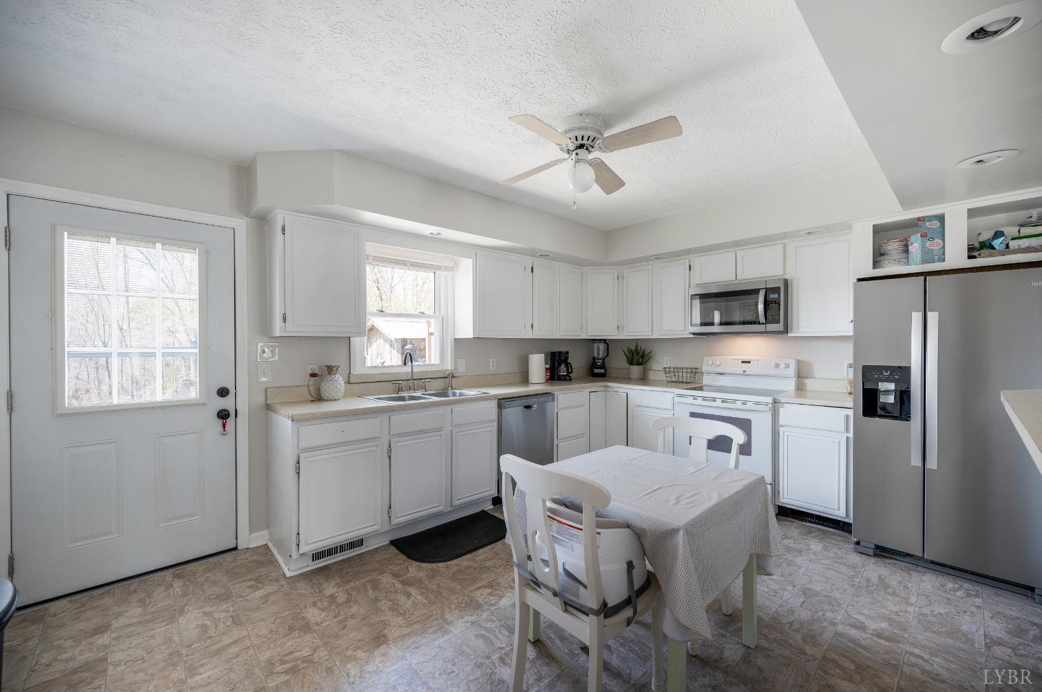 2050 Hawkins Mill Road Lynchburg, VA 24503 - Photo 8 of 32 a kitchen with white cabinets and stainless steel appliances