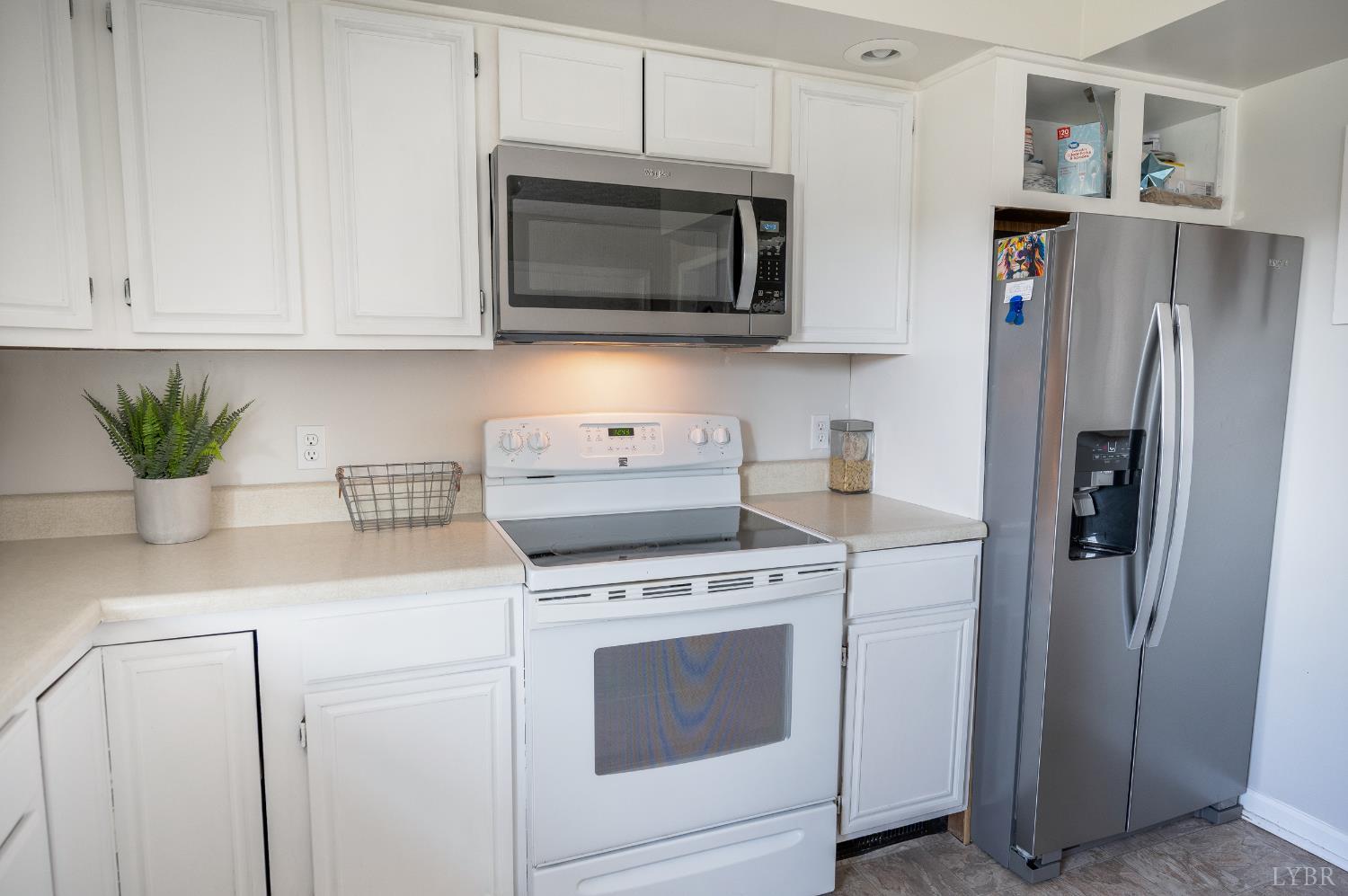 2050 Hawkins Mill Road Lynchburg, VA 24503 - Photo 10 of 32 a kitchen with stainless steel appliances white cabinets white stove a refrigerator and a microwave