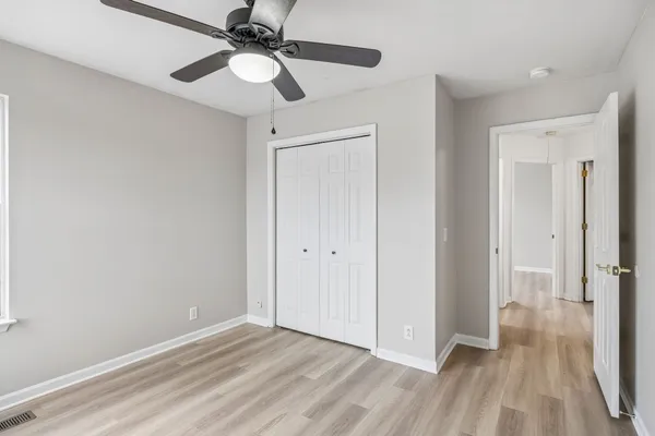 a view of an empty room and wooden floor