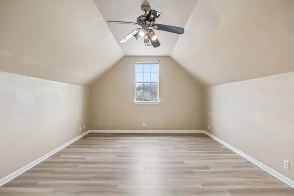 a view of a room with wooden floor and window