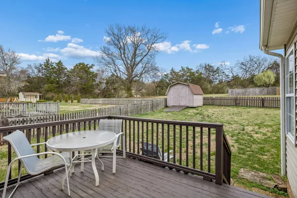 a view of a chair and table on the deck