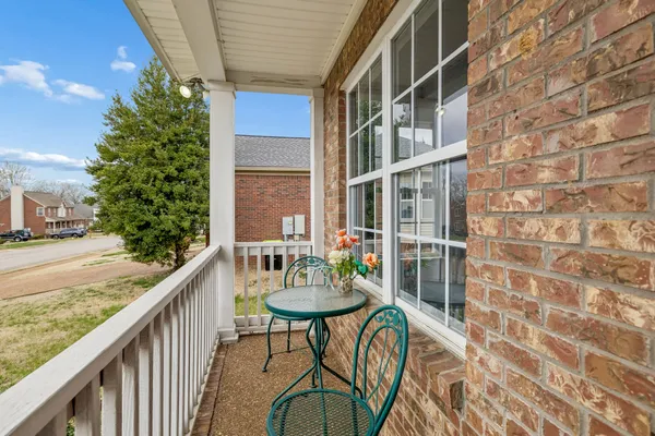 a balcony with table and chairs