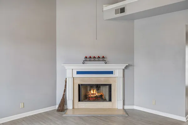 a living room with a fireplace and a fireplace
