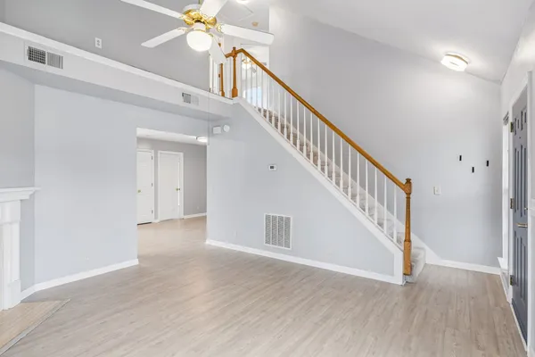 a view of staircase with white walls and a window