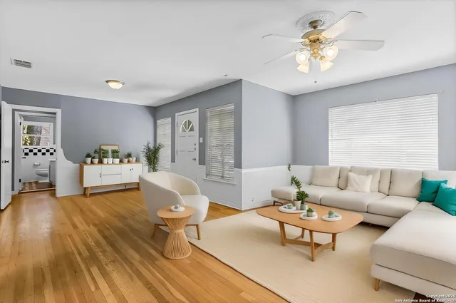 a living room with furniture and wooden floor