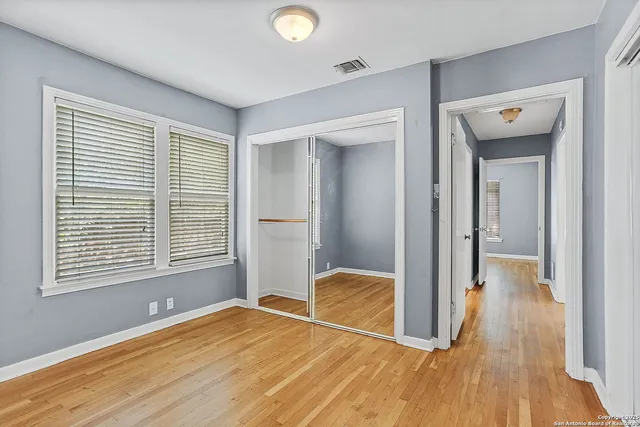 a view of a room with wooden floor and a window